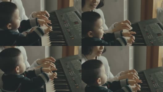 一位中国母亲教她的儿子弹钢琴高清在线视频素材下载
