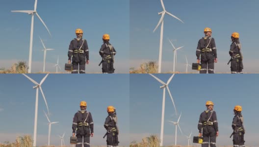 在泰国风电场，两名亚洲工程师在统一的检查工程师准备和进度检查风力发电机的安全。高清在线视频素材下载