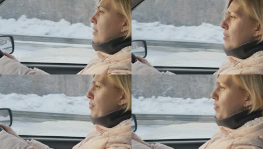 一个年轻的白人女子在冬天开着一辆车行驶在下雪的高速公路上高清在线视频素材下载