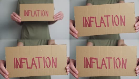 全球通胀的概念。女人拿着纸与字通货膨胀高清在线视频素材下载