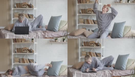 早晨，一个穿着轻睡衣的男人坐在床上，合上笔记本电脑，愉快地跳跃着，享受着生活。高清在线视频素材下载