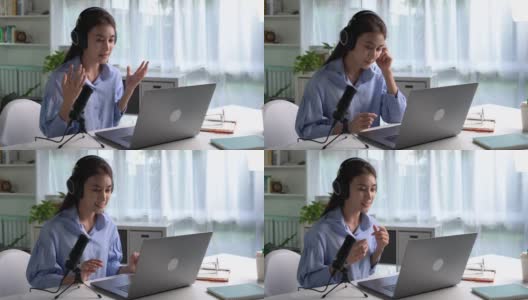 在工作中感到快乐和积极。年轻的亚洲女商人戴着耳机在笔记本电脑上与客户进行视频通话。年轻的亚洲女性提供在线教育课程讲座，咨询客户。高清在线视频素材下载