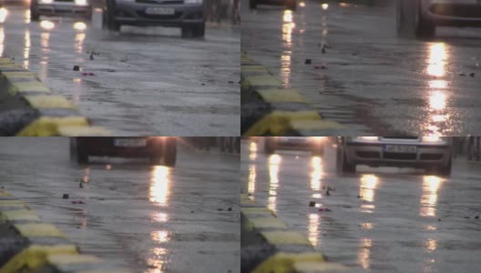 汽车低速行驶时，车灯映照在潮湿的路面和池塘里高清在线视频素材下载