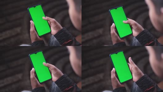 近距离的年轻人手使用智能手机与绿色屏幕高清在线视频素材下载