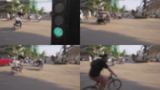 交通信号灯接近十字路口的散焦镜头，显示城市的交通状况高清在线视频素材下载