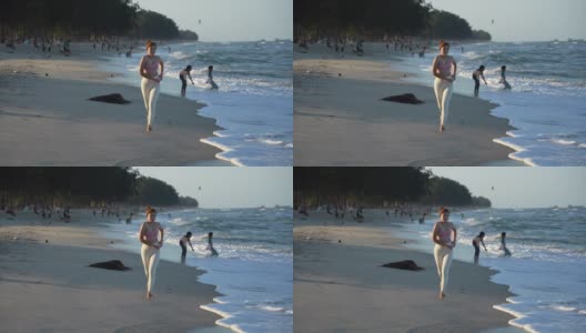 健康的生活方式年轻女子在海滩上跑步高清在线视频素材下载