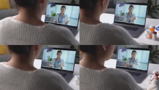 亚洲女患者在电脑上的网络摄像头会议上与医生在线交谈咨询。高清在线视频素材下载