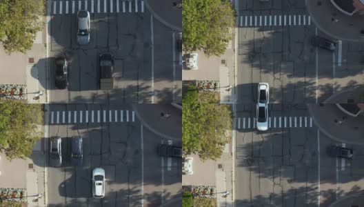 空中的俯仰无人机视图的行人在道路上的交叉。汽车在城市街道上行驶。伊利诺斯州内伯维尔大街上的许多家庭。高清在线视频素材下载