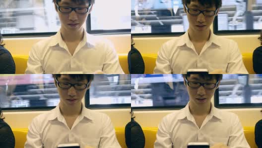 一名年轻人在火车上使用手机高清在线视频素材下载