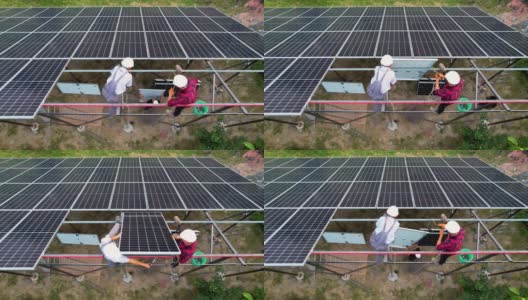 工人们在金属横梁上举起太阳能电池板高清在线视频素材下载