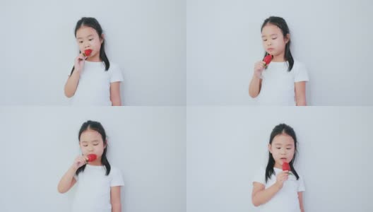 吃草莓的亚洲女孩。高清在线视频素材下载