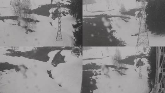 透过窗户，你可以看到从缆车下降到到达站，经过树木和滑雪者在雪道上高清在线视频素材下载