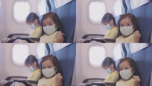 亚洲小女孩喜欢带着口罩在飞机上使用数码平板电脑高清在线视频素材下载