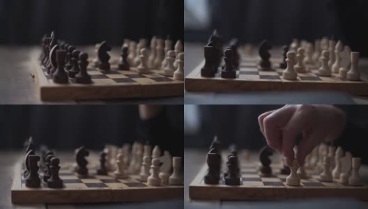 近距离跟踪镜头，无法识别的棋手执行移动与棋子在棋盘上黑暗的房间。高清在线视频素材下载