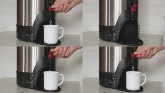 4 k。特写镜头:一个男人的手从一个热水壶里往一个白色杯子里倒茶或咖啡的热水。高清在线视频素材下载