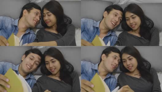 一对快乐的年轻夫妇躺在床上看书高清在线视频素材下载