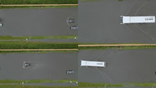 城市交通鸟瞰图，汽车行驶在暴雨后被淹没的街道上。道路排水系统的问题。高清在线视频素材下载