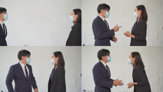 两名带着防护面罩的亚洲商人用肘撞来打招呼，而不是握手。在冠状病毒或Covid-19大流行期间，常见的问候用语高清在线视频素材下载
