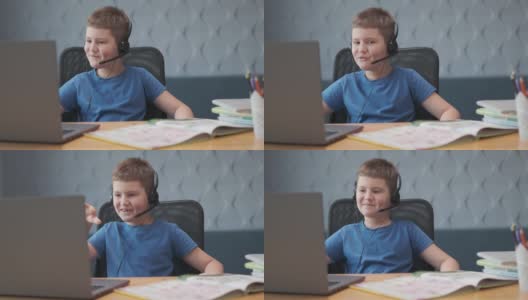 微笑的学生男孩在远程学校的电脑上学习网络，浏览和搜索互联网或其他活动，如社交媒体或在线游戏的概念高清在线视频素材下载