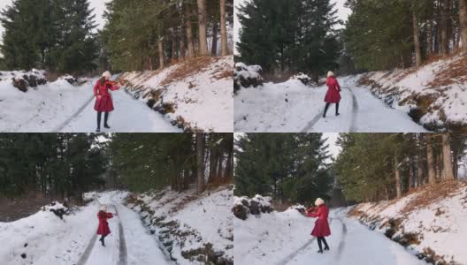 一个女人在冰冻的森林里的路上跳舞拉小提琴高清在线视频素材下载