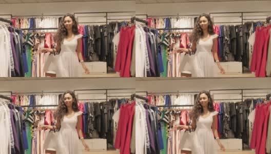 女孩走在时尚的白色礼服服在服装店和时尚精品购物中心高清在线视频素材下载
