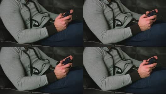 男人的手在沙发上用游戏手柄玩电子游戏的特写镜头高清在线视频素材下载
