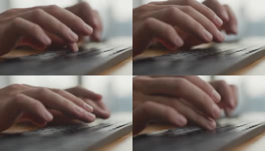手年轻的商人忙于工作的电脑键盘微缩镜头。近距离男子坐在家庭办公室的桌子和工作与PC软件应用技术在线。用键盘打字的人高清在线视频素材下载