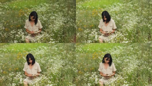 女人们用钢笔或绘画，在笔记本上书写鲜花盛开的草甸高清在线视频素材下载