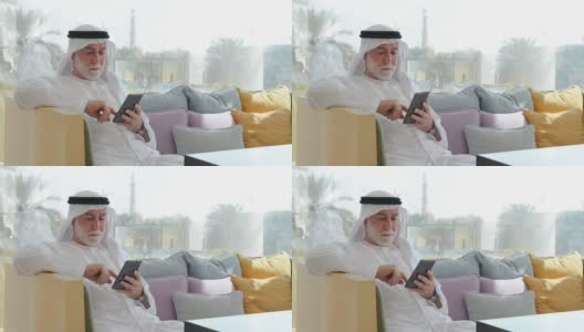 一名阿联酋男子在用智能手机高清在线视频素材下载
