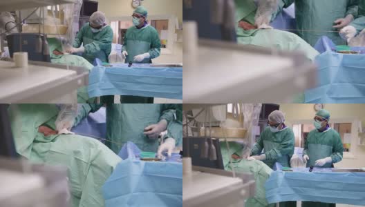 两名身穿防护服的医生在手术室工作高清在线视频素材下载