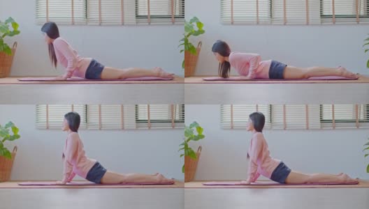 健康迷人的亚洲女性在休闲做瑜伽Cobra姿势在家里冥想舒适和放松，冷静的健康年轻女性深呼吸和冥想与瑜伽在家里，瑜伽概念高清在线视频素材下载