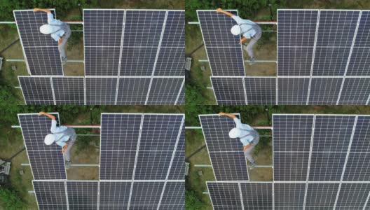 图为男工人正在安装光伏太阳能电池板。高清在线视频素材下载