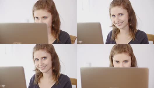 坐在笔记本电脑屏幕后面的年轻女子高清在线视频素材下载
