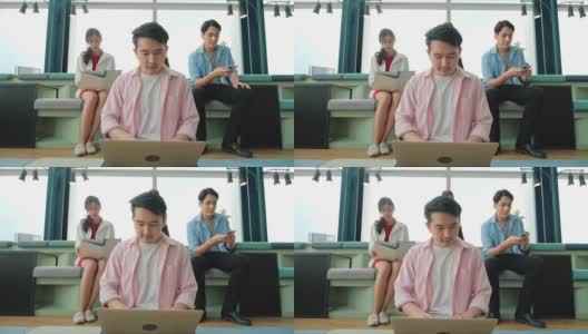 一群亚洲高中生在办公室会议室里开会，用笔记本电脑分析统计数据、分析市场，并考虑营销活动。高清在线视频素材下载