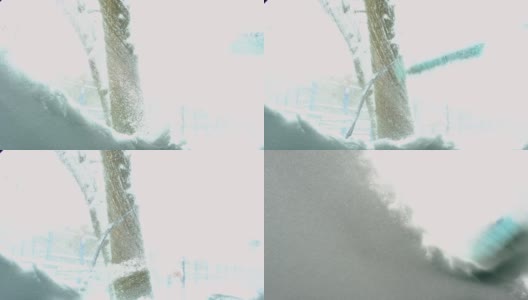 一名男子在雪景后从车内刷雪。夹克里的一只手，白色的身体上放着一把汽车扫把。冬天的天气条件。慢动作高清在线视频素材下载