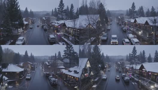 寒冷的冬夜驾车穿过白雪覆盖的圣诞灯装饰村庄，空中拍摄高清在线视频素材下载