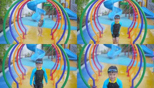 亚洲男孩在水上公园的水下玩耍和游泳高清在线视频素材下载