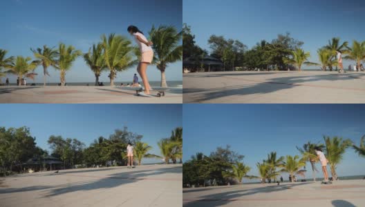 亚洲女孩在公园户外玩冲浪滑板在阳光明媚的日子与椰子树的背景，生活方式的概念。高清在线视频素材下载