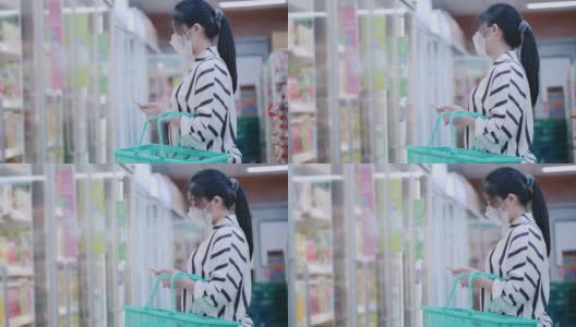 亚洲妇女在超市使用电话高清在线视频素材下载