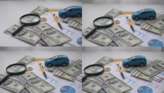汽车保险的概念。汽车模型驾驶在金钱和保险文件的背景高清在线视频素材下载