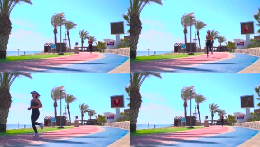 北塞浦路斯法马古斯塔的长滩上，妇女们在沙滩旁的跑道上跑步高清在线视频素材下载