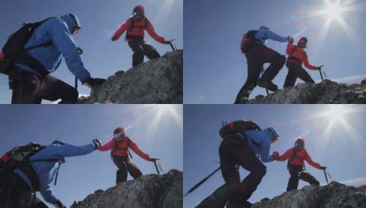 登山者在山上互相帮助翻越岩石高清在线视频素材下载