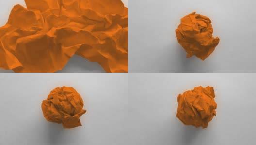 皱巴巴的橙色纸球高清在线视频素材下载