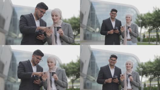 商务人士在户外喝咖啡休息。快乐可爱的印度男人和他的办公室同事聊天，漂亮的穆斯林女人戴着头巾，在智能手机上展示一些东西。一起喝咖啡。高清在线视频素材下载