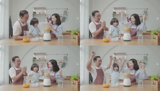 亚洲家庭，爸爸妈妈和儿子帮忙做饭在厨房做冰沙高清在线视频素材下载
