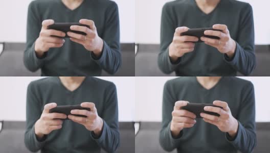 一名亚洲男子在智能手机上玩游戏高清在线视频素材下载