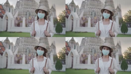 带着口罩的亚洲女性游客正在泰国曼谷的阿伦寺旅行。高清在线视频素材下载