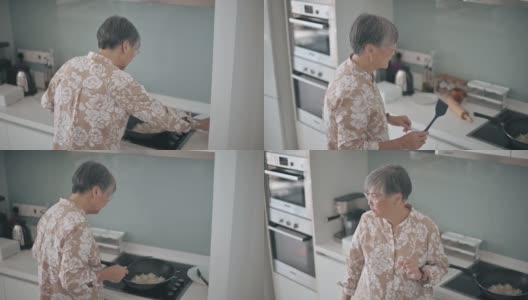 亚洲华人奶奶在周末闲暇时间在厨房做饭高清在线视频素材下载
