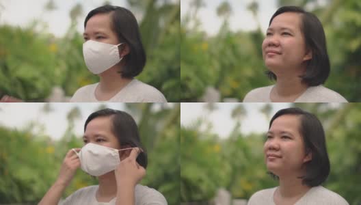 亚洲女性摘下面具，在大自然中微笑高清在线视频素材下载