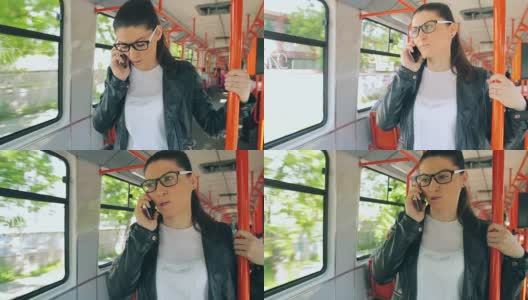 漂亮的年轻女性在火车上讲手机。高清在线视频素材下载